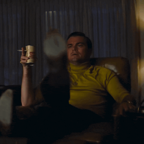 Rick Dalton pointing at a television screen